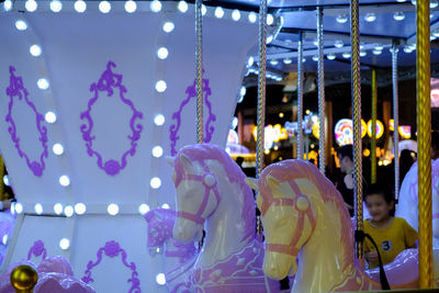 People at amusement park ride at night