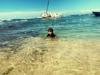 Boy swimming in sea