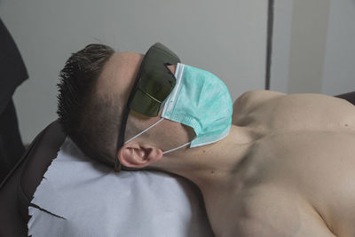 Young man sleeping on bed