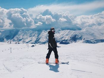 Tourists on snow covered mountain