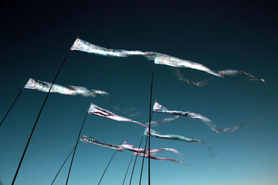 Low angle view of windmill against blue sky