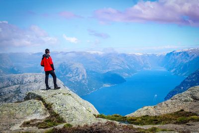 Man standing on mountain against sky