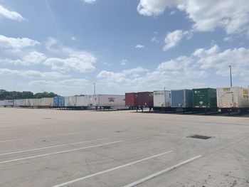 Train on railroad tracks in city against sky