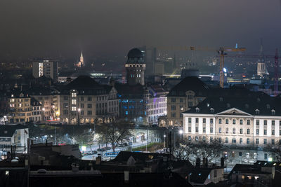 High angle view of buildings in city at night