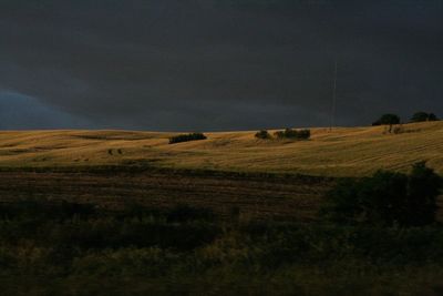 Hay bales on field against sky