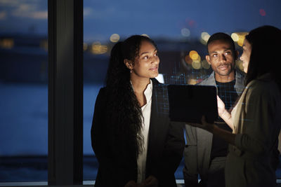 Three young business people working together in office