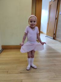 Full length portrait of cute ballerina girl 