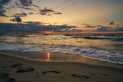 Epic dark sunset sky above the sea shore after the storm.