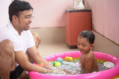 Happy boy and girl enjoying in water