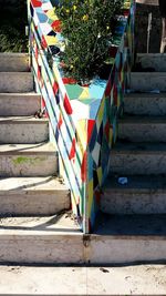 Multi colored flag on staircase against sky