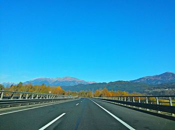 Empty road leading towards mountains