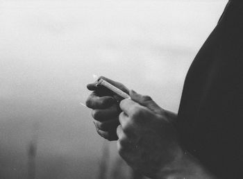 Close-up of man holding cigarette