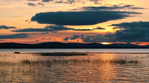 Dramatic cloudy sunset scenery, mountains in background at corrib lake in galway, ireland