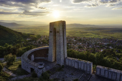 Old ruin on landscape against sky during sunset