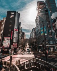 Panoramic view of city street and buildings against sky