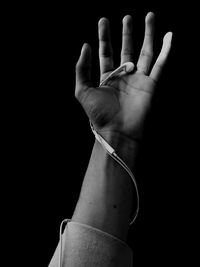 Close-up of human hand against black background