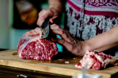 Close-up of man preparing food on cutting board