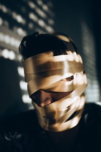 Close-up of man with face covered by tape