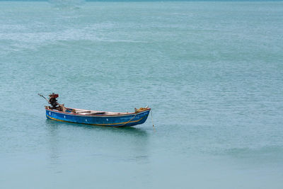 Man sitting on boat sailing in sea