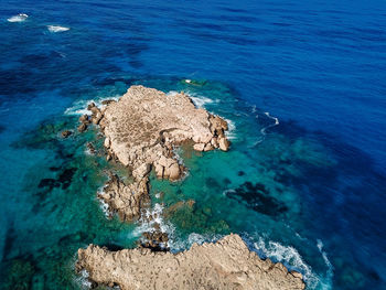 High angle view of rock formation in sea