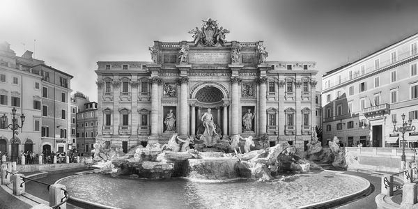 Statue of fountain in city against sky