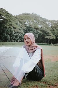 Portrait of young woman with umbrella