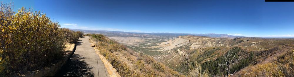 Panoramic view of road by mountains against sky