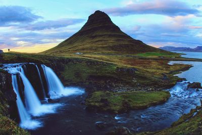 Scenic view of waterfall against sky