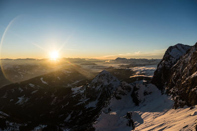 Scenic view of snowcapped mountains against sky during sunset