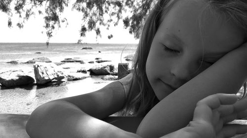 Midsection of woman sitting on beach