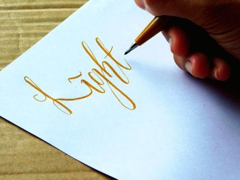 Close-up of human hand holding paper