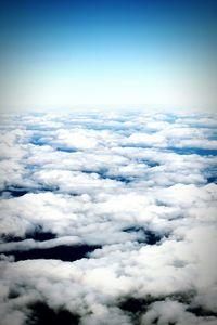 Aerial view of mountain range against cloudy sky