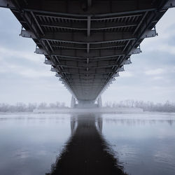 View of bridge over river against cloudy sky