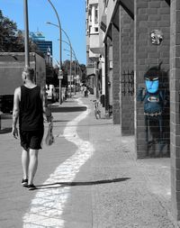 Rear view of man walking on street