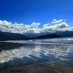 Scenic view of lake against cloudy sky