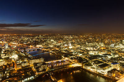 High angle view of illuminated buildings in city at night