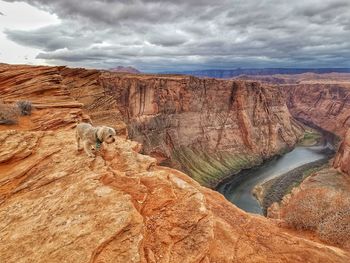 View of rock formations against cloudy sky