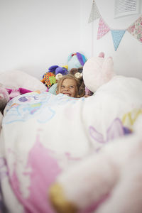 Smiling girl lying in bed