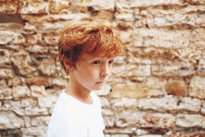 Boy standing against wall