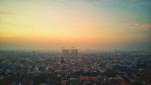 High angle view of illuminated buildings against sky during sunset