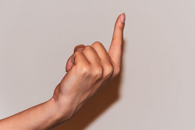 Close-up of human hand against white background