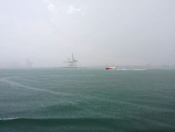 Scenic view of sea against cloudy sky
