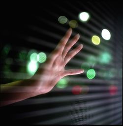 Cropped image of woman standing on illuminated street