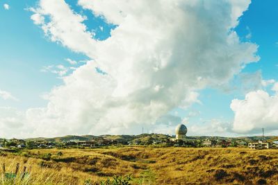 Panoramic view of agricultural field against sky