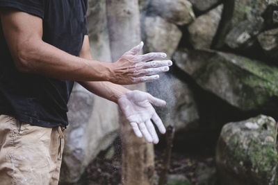 Close up of climber hands clapping chalk