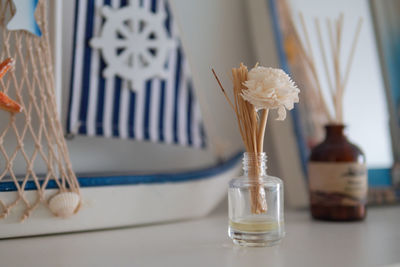 Close-up of white flower vase on table at home