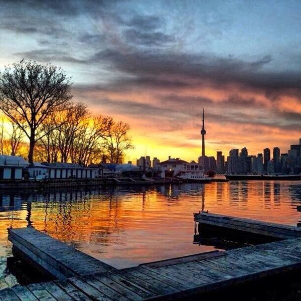 sunset, architecture, built structure, building exterior, sky, cloud - sky, water, city, river, silhouette, tree, orange color, tower, cityscape, cloudy, travel destinations, cloud, tall - high, lake, reflection