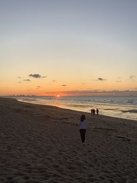 Scenic view of beach against sky during sunset