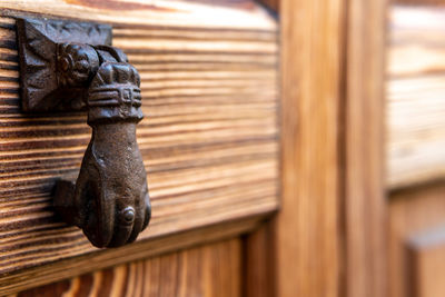 Close-up of door knob on wooden door