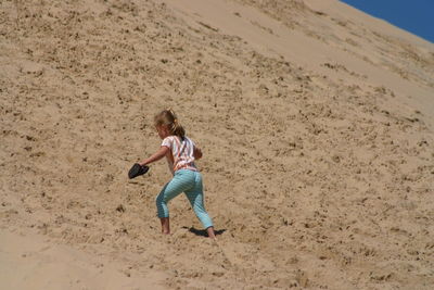 Full length of woman standing on beach